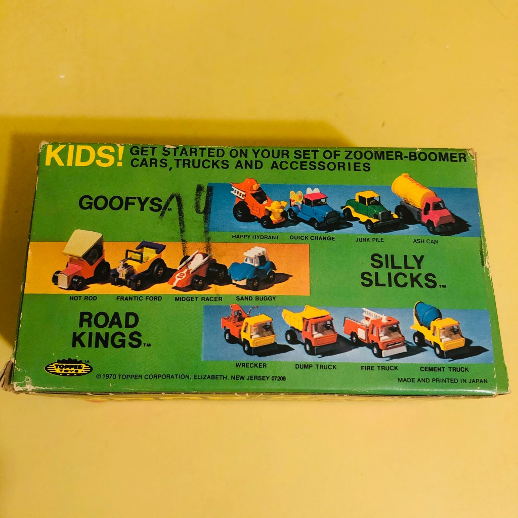 A box showing 12 Topper Toys Zoomer-Boomer cars and trucks. Many are cartoon cars or show rods.