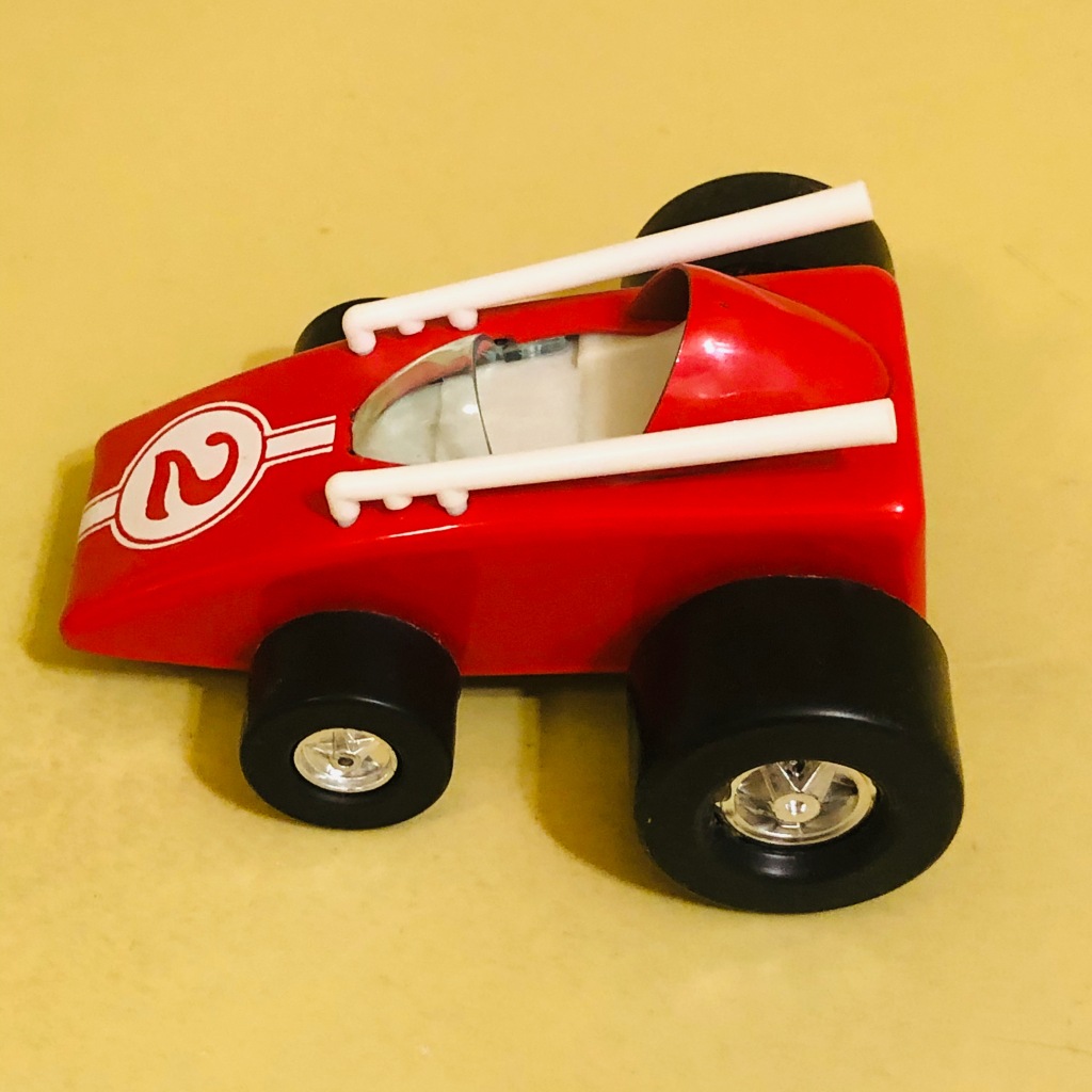 A toy car by Topper Toys called the Zoomer-Boomer Midget Racer. It is a show rod or cartoon car.